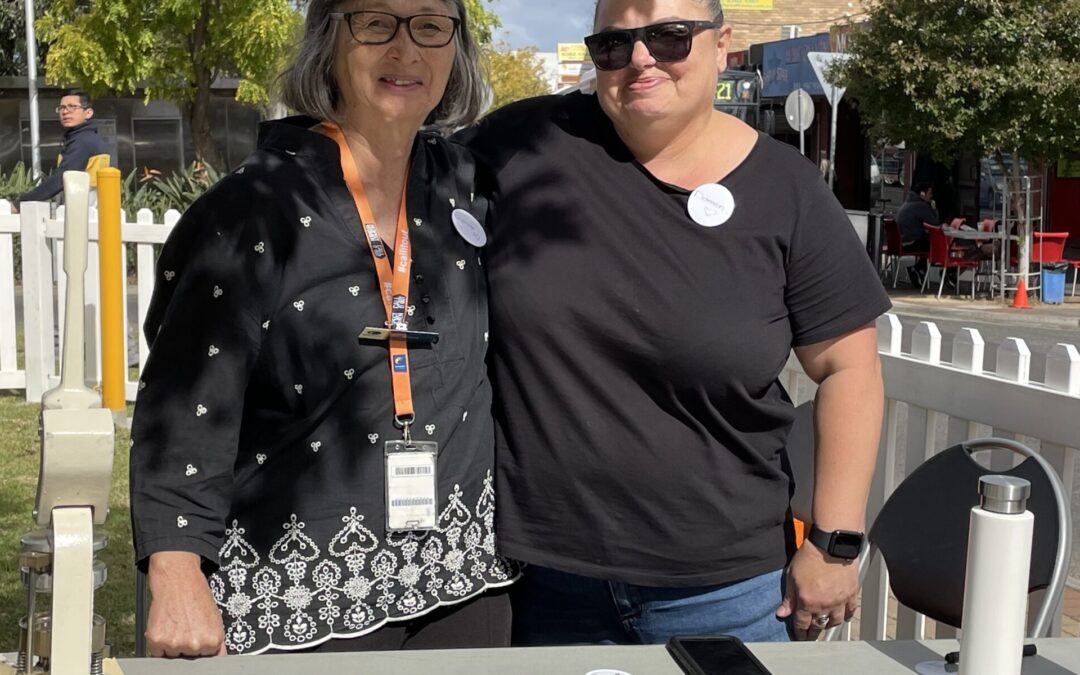 Two women standing side by side