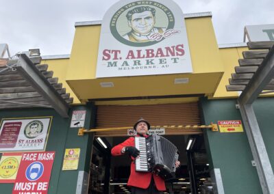Man with accordion outside market