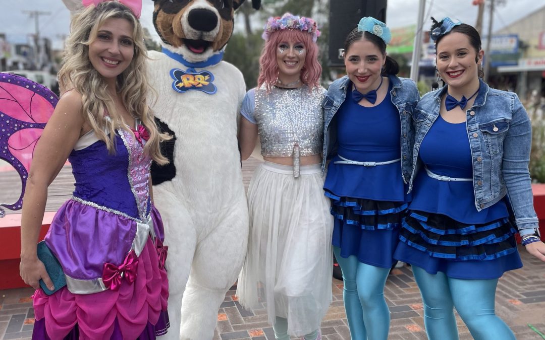Group of female entertainers with a dog mascot