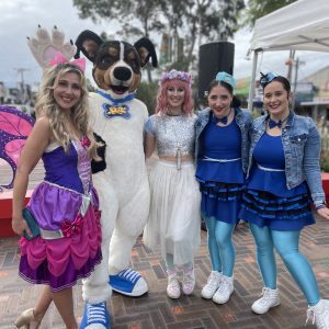 Group of female entertainers with a dog mascot