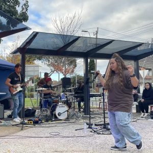 Woman singing with band
